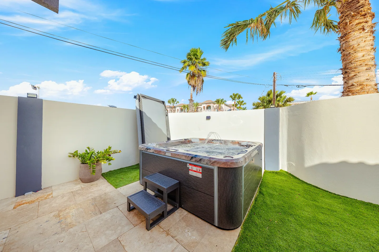 Private outdoor jacuzzi area with greenery in Aruba