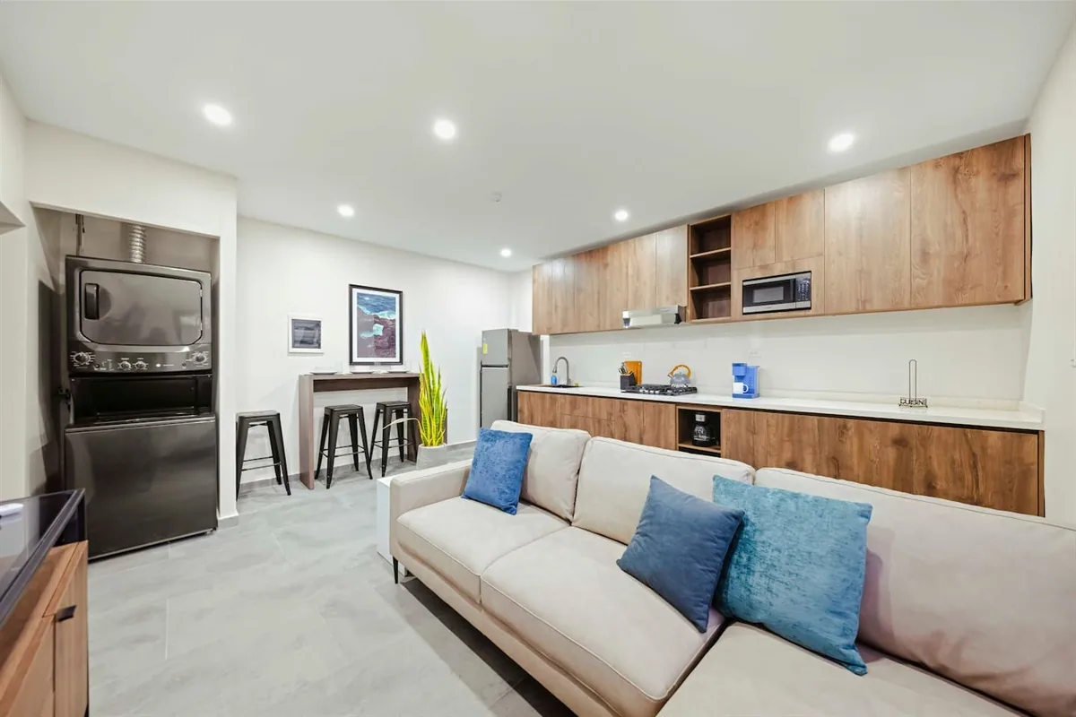 Sofa and wood-cabinet kitchen area of Sea La Vie Suite 5.