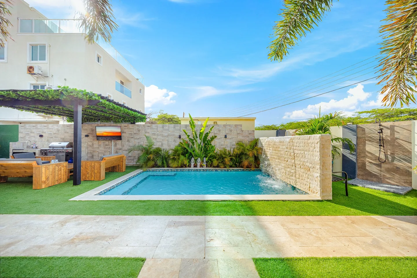 Pool waterfall and lounge area at Sea La Vie